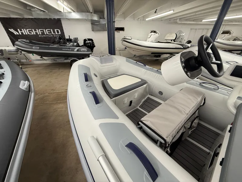 Slide: The Image of 2025 Highfield Classic 310 FCT boat in showroom, featuring sleek design and modern controls. - 4