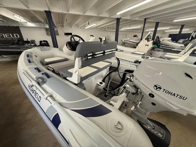 Slide: The Image of 2025 Highfield Classic 310 FCT boat with Tohatsu engine in showroom. - 5