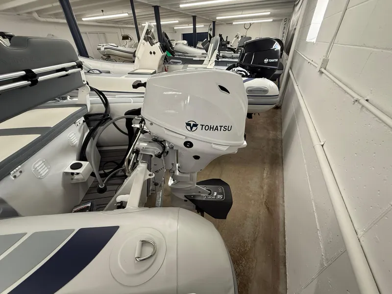 Slide: The Image of 2025 Highfield Classic 310 FCT with Tohatsu engine in a showroom. - 6