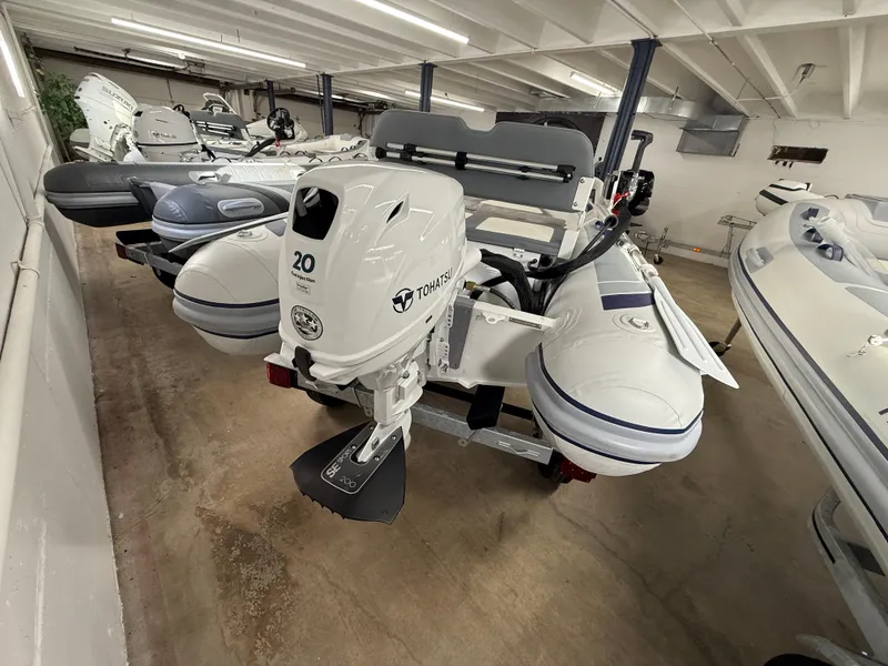 Slide: The Image of 2025 Highfield Classic 310 FCT boat with Tohatsu engine in showroom. - 7