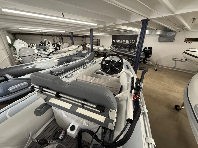 Slide: The Image of 2025 Highfield Classic 310 FCT boat in showroom, featuring sleek design and modern controls. - 8