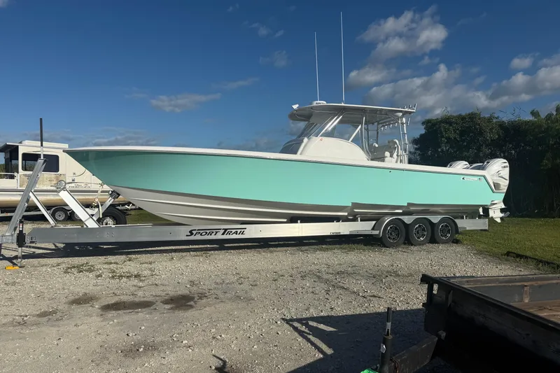 The Image of 2023 Contender 39 Fisharound boat on trailer under blue sky. - 0