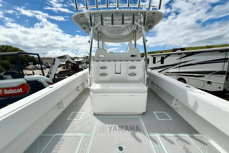 Slide: The Image of 2023 Contender 39 Fisharound boat interior with seating and Yamaha branding under a blue sky. - 4