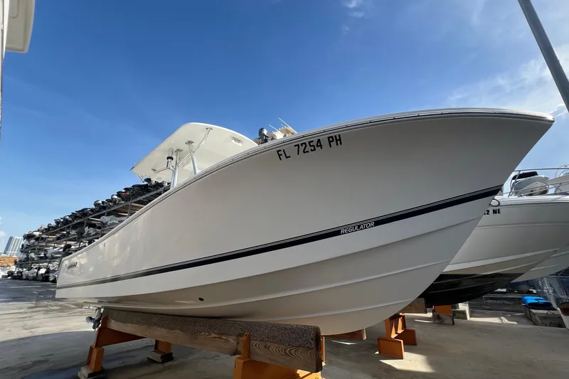The Image of 2012 Regulator 24 Forward Seating boat on display under clear blue sky. - 0
