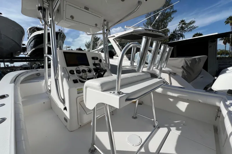 Slide: The Image of 2012 Regulator 24 Forward Seating boat interior with helm and rod holders. - 11