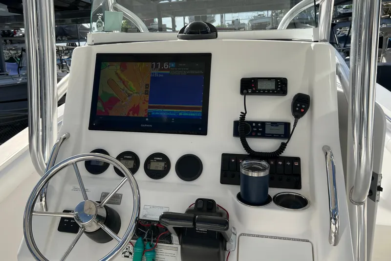 Slide: The Image of 2012 Regulator 24 Forward Seating boat dashboard with Garmin navigation system and controls. - 12