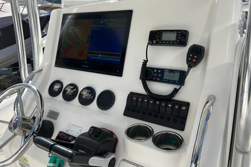 Slide: The Image of Control panel of 2012 Regulator 24 Forward Seating boat with Garmin display and radio equipment. - 14