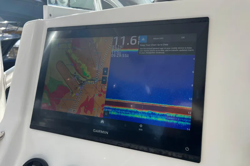 Slide: The Image of Garmin marine display on 2012 Regulator 24 Forward Seating boat, showing navigation and sonar data. - 16