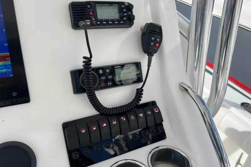 Slide: The Image of 2012 Regulator 24 Forward Seating boat dashboard with radio and control panel. - 18