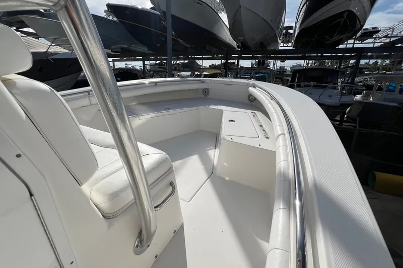 Slide: The Image of 2012 Regulator 24 Forward Seating boat interior with white upholstery and stainless steel railings. - 21