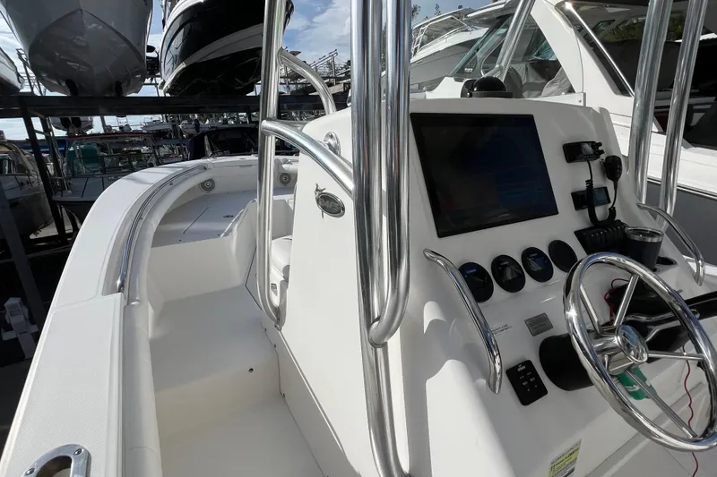 Slide: The Image of 2012 Regulator 24 Forward Seating boat interior with steering wheel and control panel. - 23