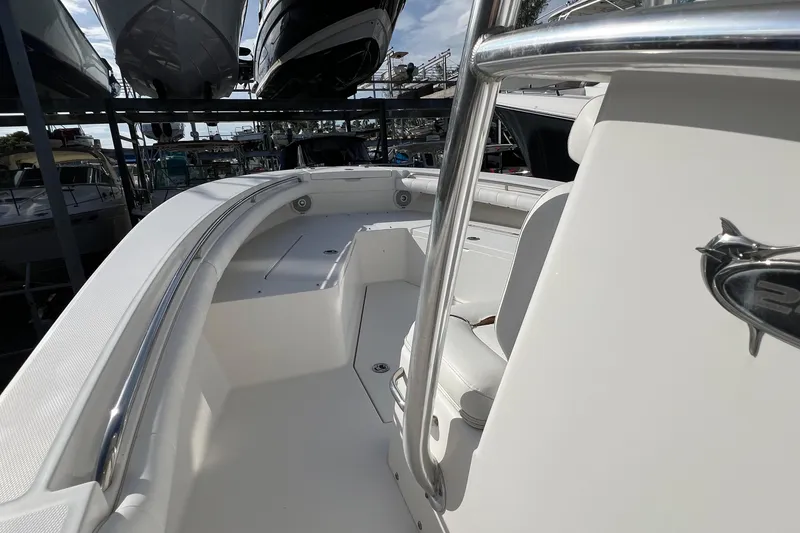 Slide: The Image of 2012 Regulator 24 Forward Seating boat interior with white upholstery and stainless steel railings. - 24