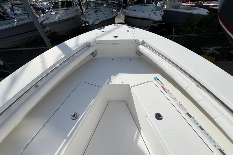 Slide: The Image of 2012 Regulator 24 Forward Seating boat interior with spacious deck and storage compartments. - 27