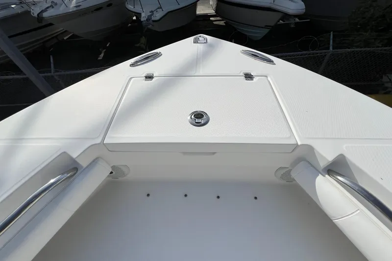 Slide: The Image of 2012 Regulator 24 Forward Seating boat deck with storage compartments and stainless steel handles. - 28
