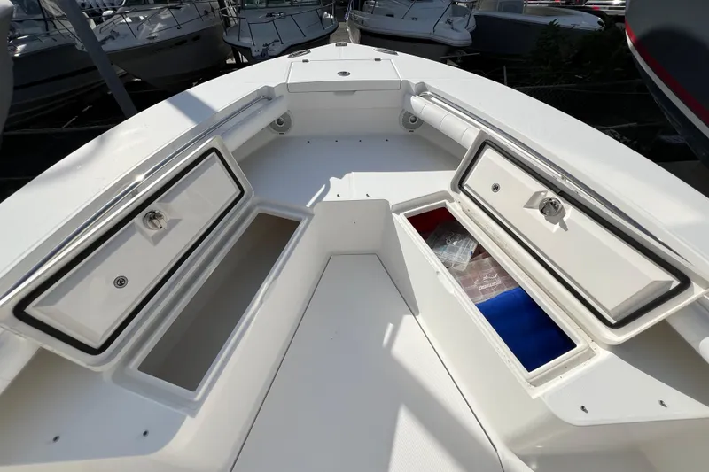 Slide: The Image of 2012 Regulator 24 Forward Seating boat with open storage compartments. - 29