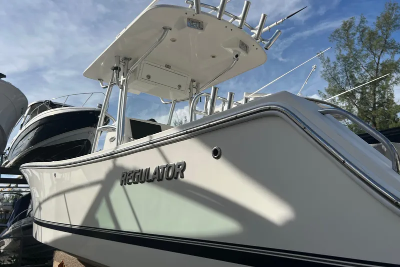 Slide: The Image of 2012 Regulator 24 Forward Seating boat under clear blue sky. - 5