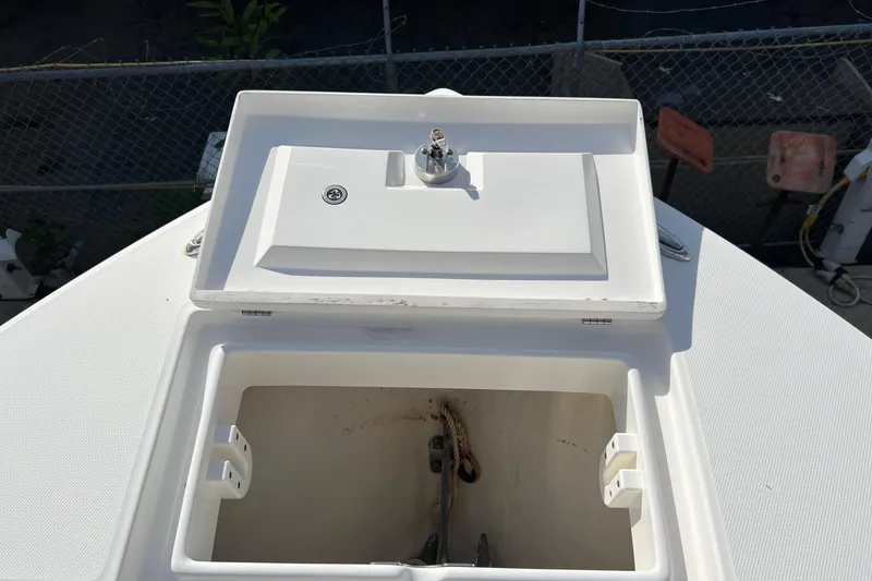 Slide: The Image of 2012 Regulator 24 Forward Seating boat anchor locker with open hatch. - 50