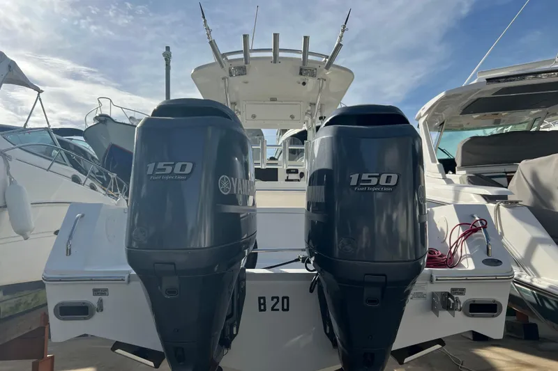Slide: The Image of 2012 Regulator 24 Forward Seating boat with twin Yamaha 150 engines at dock. - 6