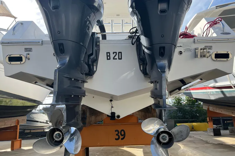 Slide: The Image of 2012 Regulator 24 Forward Seating boat with dual outboard motors on display. - 7