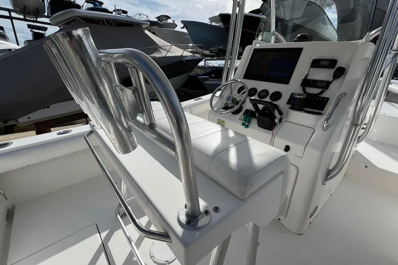 Slide: The Image of 2012 Regulator 24 Forward Seating boat interior with helm and seating area. - 9