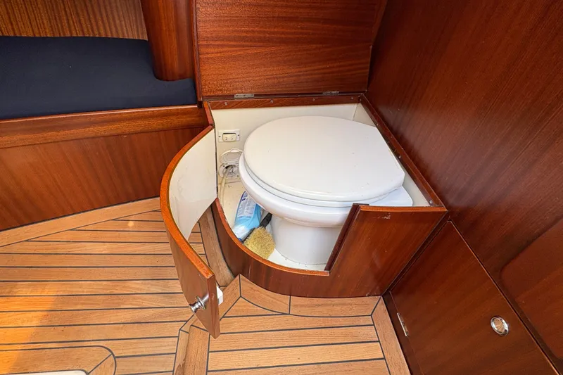 Slide: The Image of Wooden yacht bathroom with toilet, featuring elegant cabinetry in a 2017 Leonardo Eagle 44. - 20