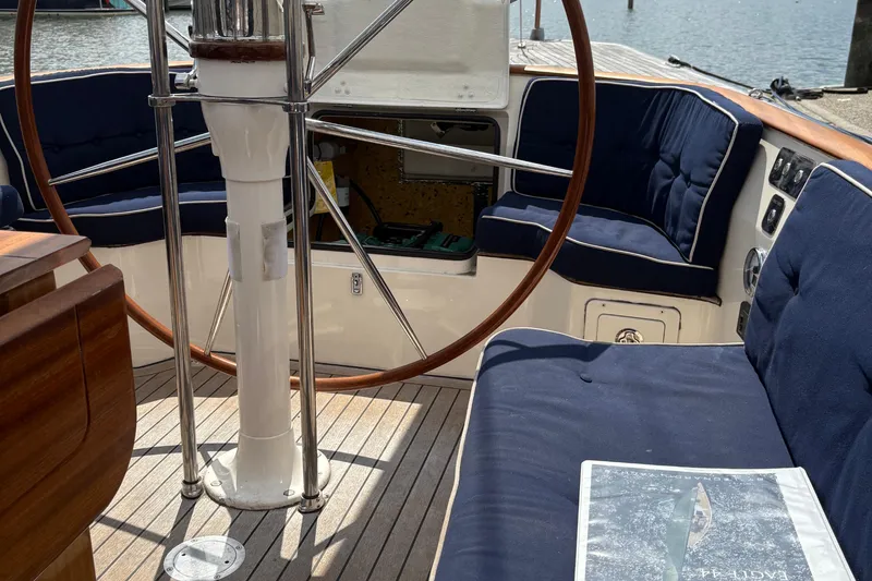 Slide: The Image of Cockpit of 2017 Leonardo Eagle 44 sailboat with wooden wheel and navy cushions. - 14