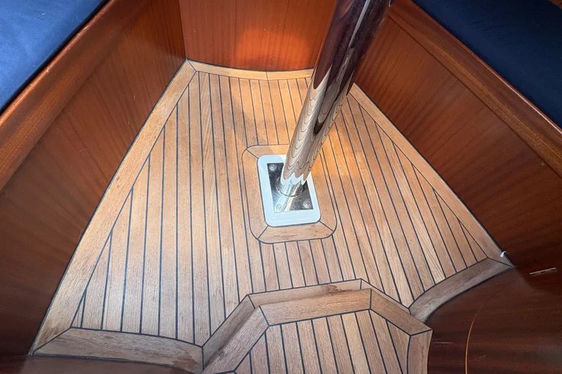 Slide: The Image of Teak interior flooring of 2017 Leonardo Eagle 44 sailboat, featuring polished metal support. - 22
