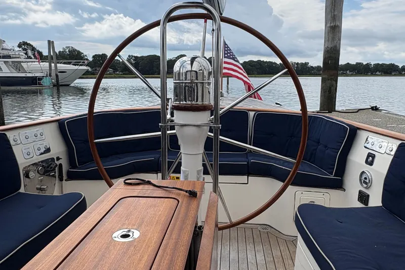 Slide: The Image of Cockpit of 2017 Leonardo Eagle 44 sailboat with wooden wheel and blue seating. - 9