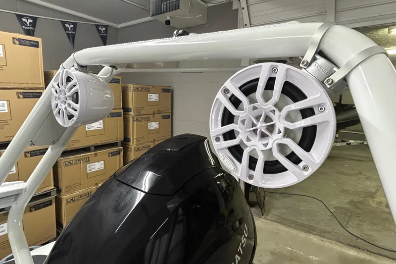 Slide: The Image of 2025 Highfield Sport 390 boat speakers and engine in a storage area. - 11
