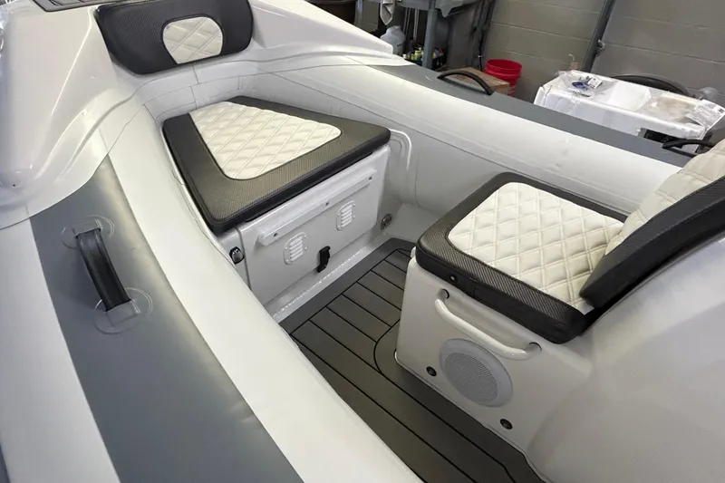 Slide: The Image of Interior of 2025 Highfield Sport 390 boat with cushioned seating and storage compartments. - 8