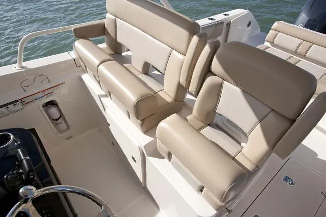 Slide: The Image of Manufacturer Provided Image: 2014 Pursuit ST 310 Sport boat interior with beige seating. - 10