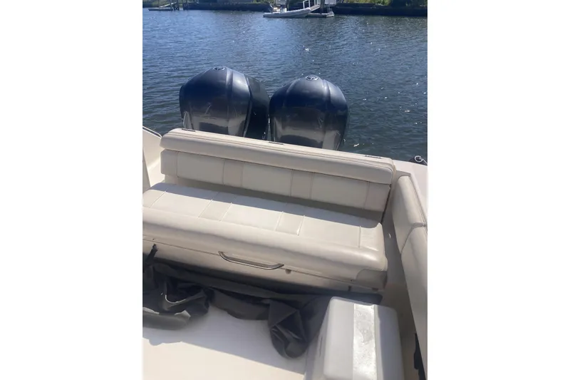 Slide: The Image of 2014 Pursuit ST 310 Sport boat with dual engines and cushioned seating. - 13