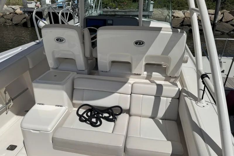 Slide: The Image of 2014 Pursuit ST 310 Sport boat interior with white seating and coiled rope. - 5