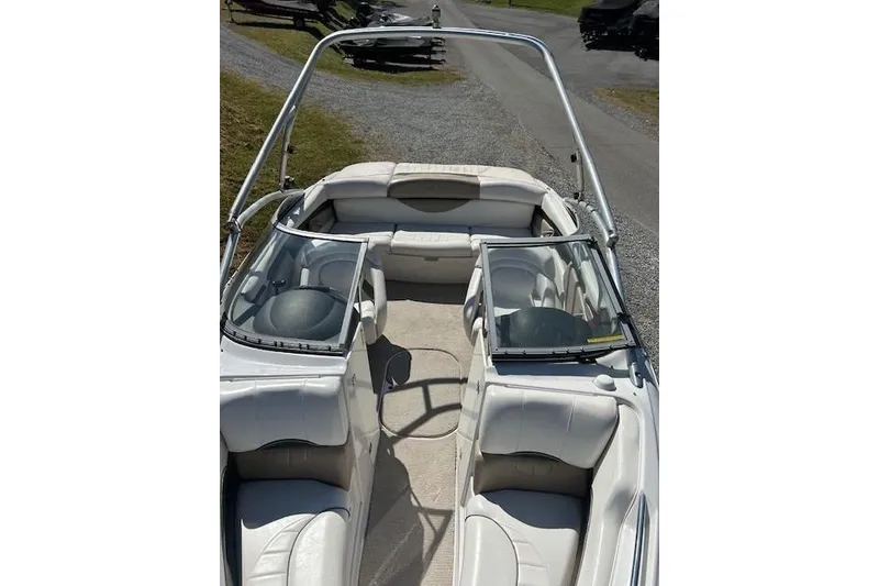 Slide: The Image of 2006 Four Winns H210 boat interior with white seating and windshield. - 12