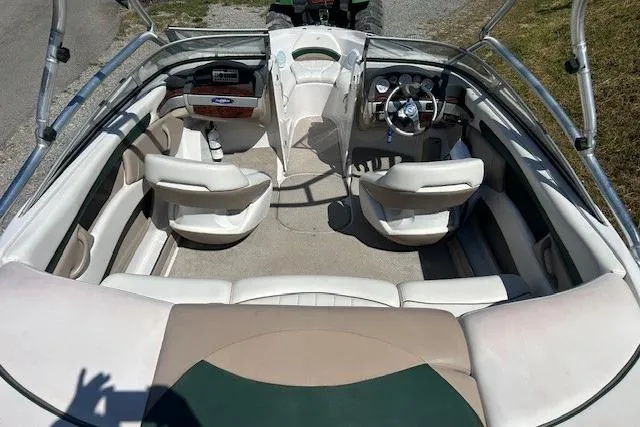 Slide: The Image of 2006 Four Winns H210 boat interior with seating and steering wheel, viewed from above. - 13