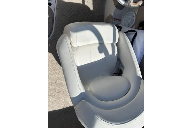 Slide: The Image of White leather seat in 2006 Four Winns H210 boat, sunlight casting shadows. - 21
