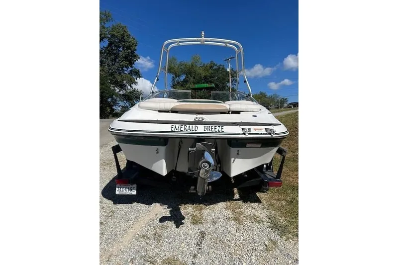 Slide: The Image of 2006 Four Winns H210 boat named "Emerald Breeze" on a trailer, sunny day. - 3