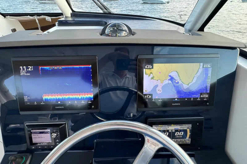 Slide: The Image of Dashboard of 2021 Pursuit DC 326 Dual Console with Garmin navigation displays. - 10