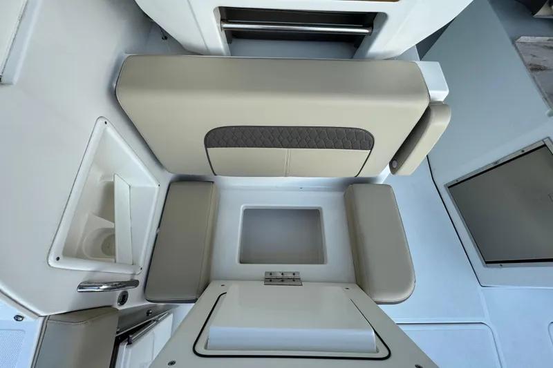 Slide: The Image of 2021 Pursuit DC 326 Dual Console interior seating and storage area. - 16