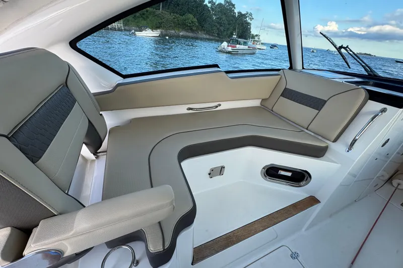Slide: The Image of 2021 Pursuit DC 326 Dual Console interior with comfortable seating and scenic water view. - 21