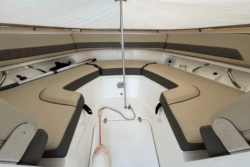 Slide: The Image of 2021 Pursuit DC 326 Dual Console boat interior with beige seating and storage compartments. - 25