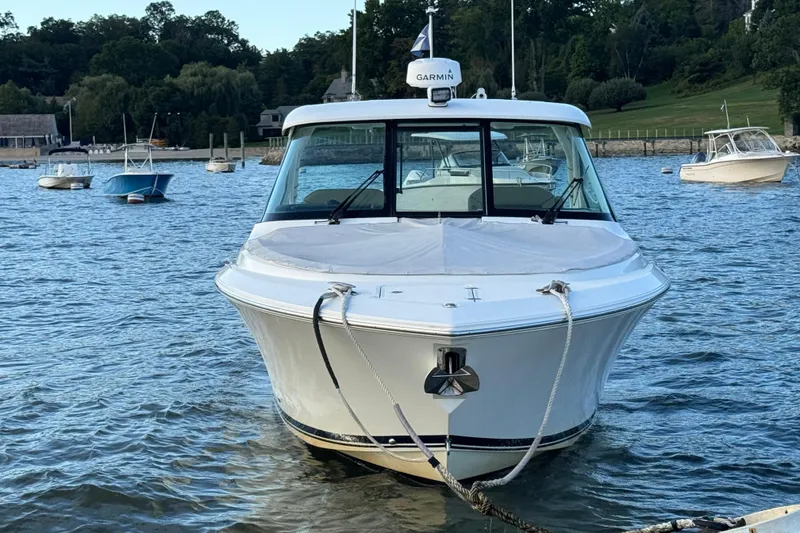 Slide: The Image of 2021 Pursuit DC 326 Dual Console boat docked on calm water. - 4