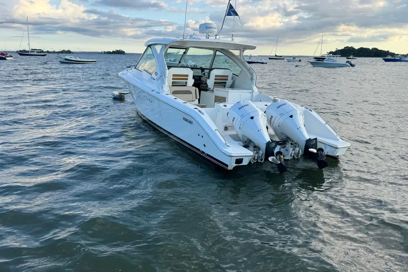 Slide: The Image of 2021 Pursuit DC 326 Dual Console boat on calm water, featuring twin engines. - 6