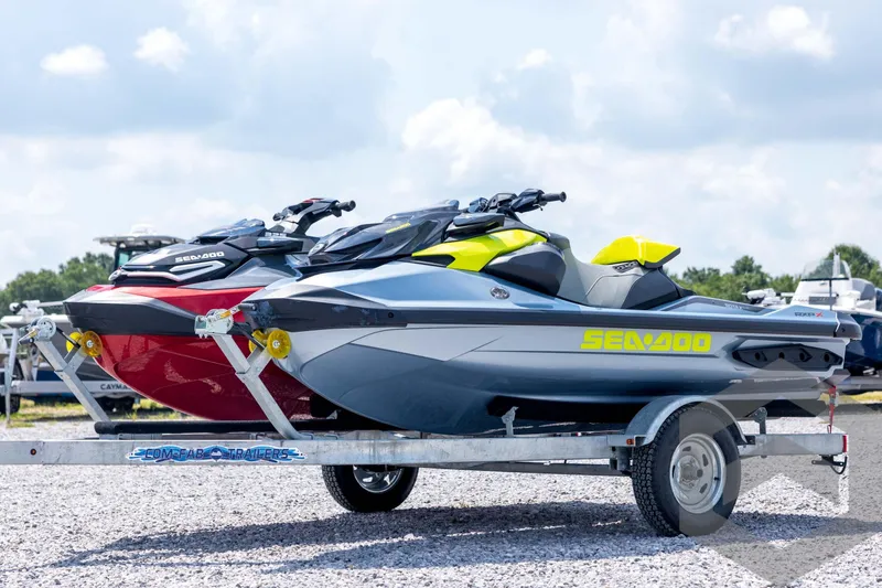 The Image of 2024 Sea-Doo RXP-X 325 jet skis on trailer, parked outdoors. - 1