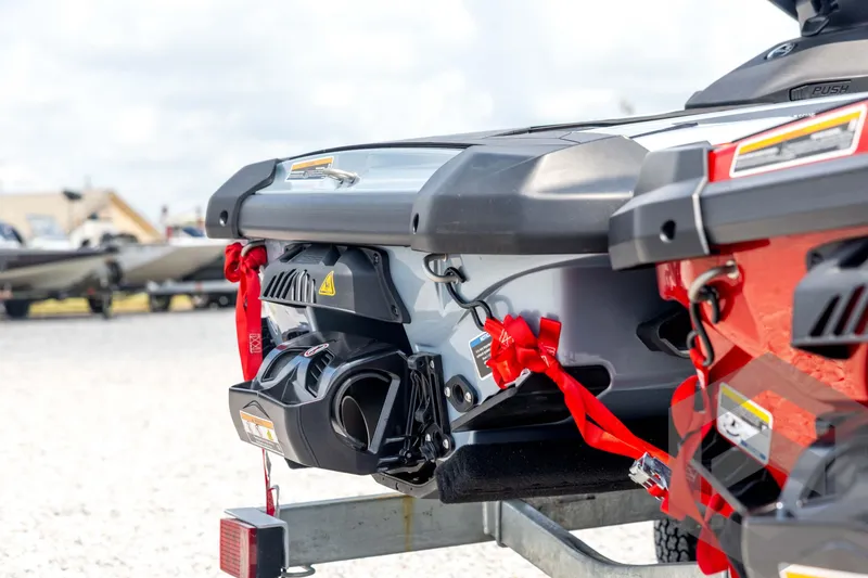 Slide: The Image of 2024 Sea-Doo RXP-X 325 jet ski rear view, secured with red straps on a trailer. - 14