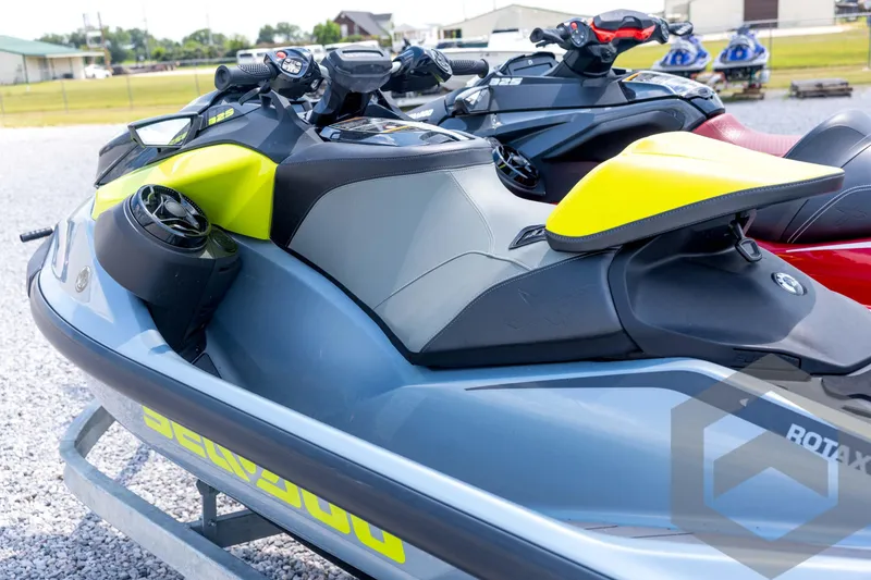 Slide: The Image of 2024 Sea-Doo RXP-X 325 jet ski in vibrant yellow and gray, parked outdoors. - 18