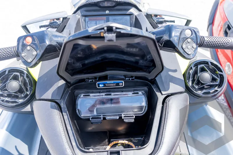 Slide: The Image of 2024 Sea-Doo RXP-X 325 dashboard with open storage compartment and control buttons. - 33