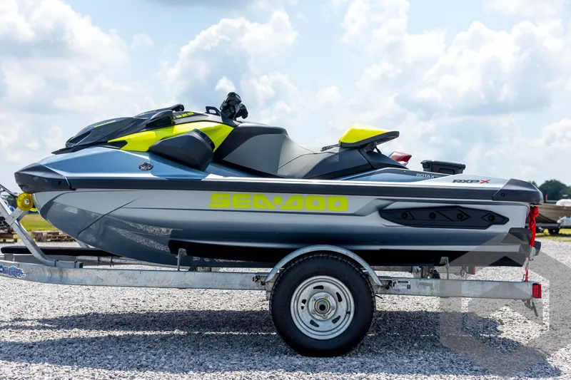 Slide: The Image of 2024 Sea-Doo RXP-X 325 jet ski on trailer, displayed outdoors under a cloudy sky. - 8