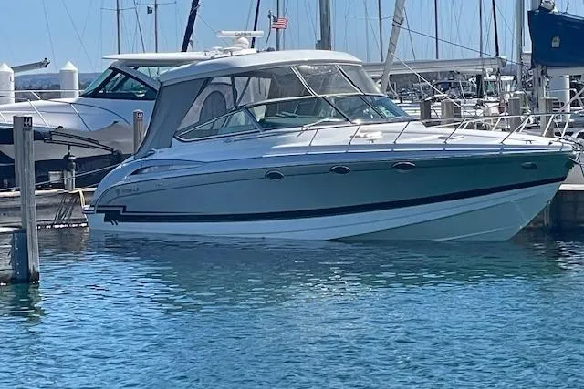 The Image of 2014 Formula 370 Super Sport boat docked in a marina, surrounded by clear blue water. - 0