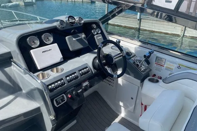 Slide: The Image of 2014 Formula 370 Super Sport boat cockpit with steering wheel and control panel. - 11